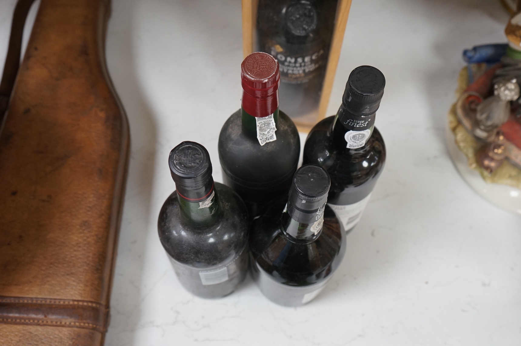 Five assorted bottles of port, including a boxed Fonseca 1988, a bottle of Calem 1987 and three other bottles of port.
